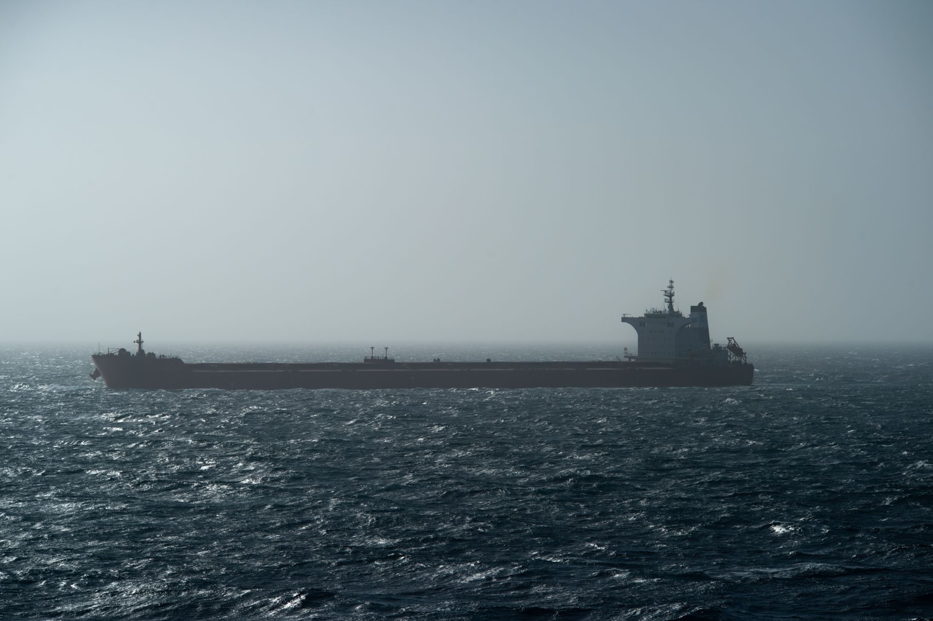 Cargo ship on open ocean at dusk