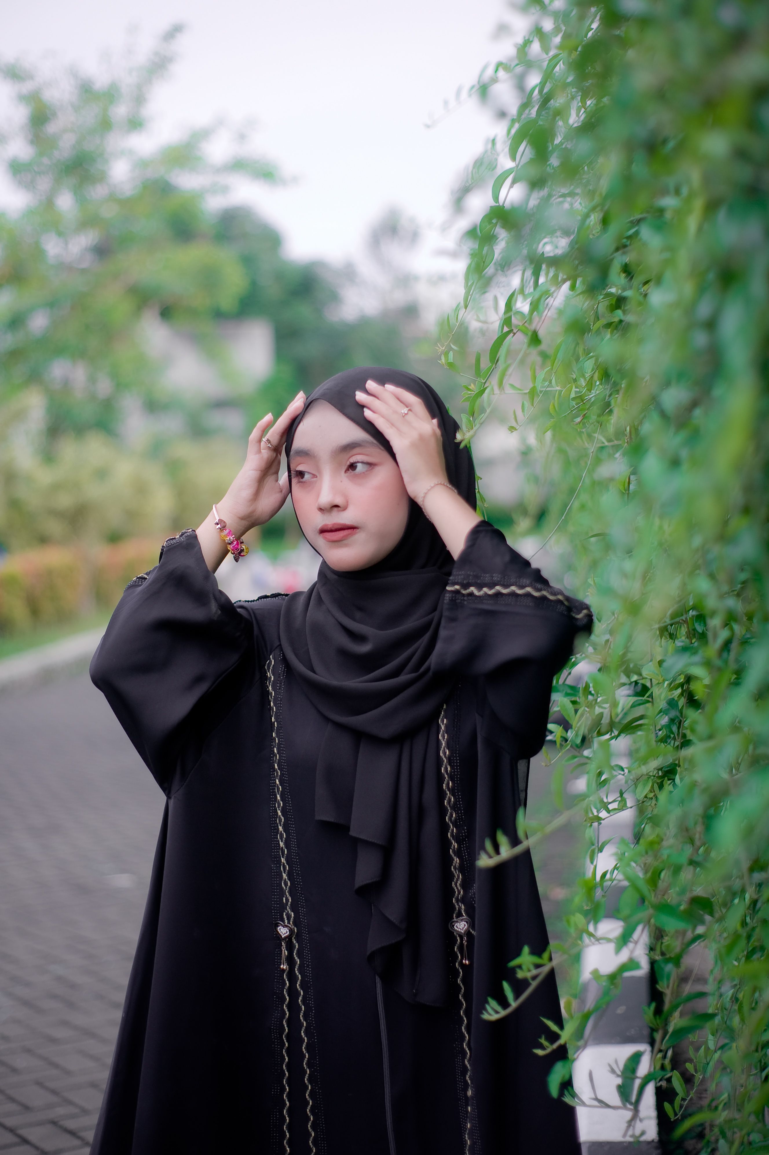 Portrait of a Young Woman in Black Hijab Outdoors · Free Stock Photo
