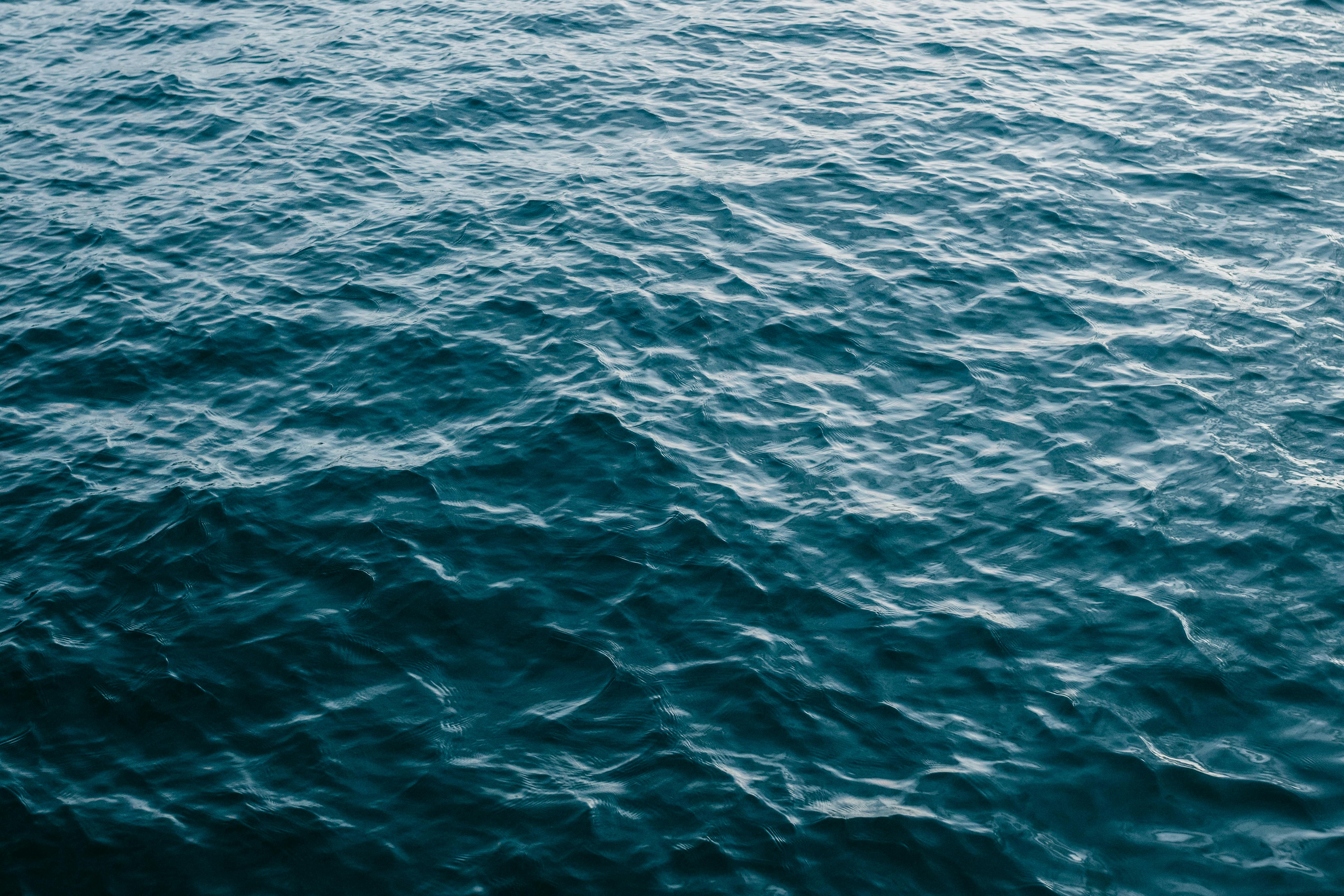 Gratis Una vista serena del agua del océano con suaves ondas que crean un patrón de superficie texturizado. Foto de stock