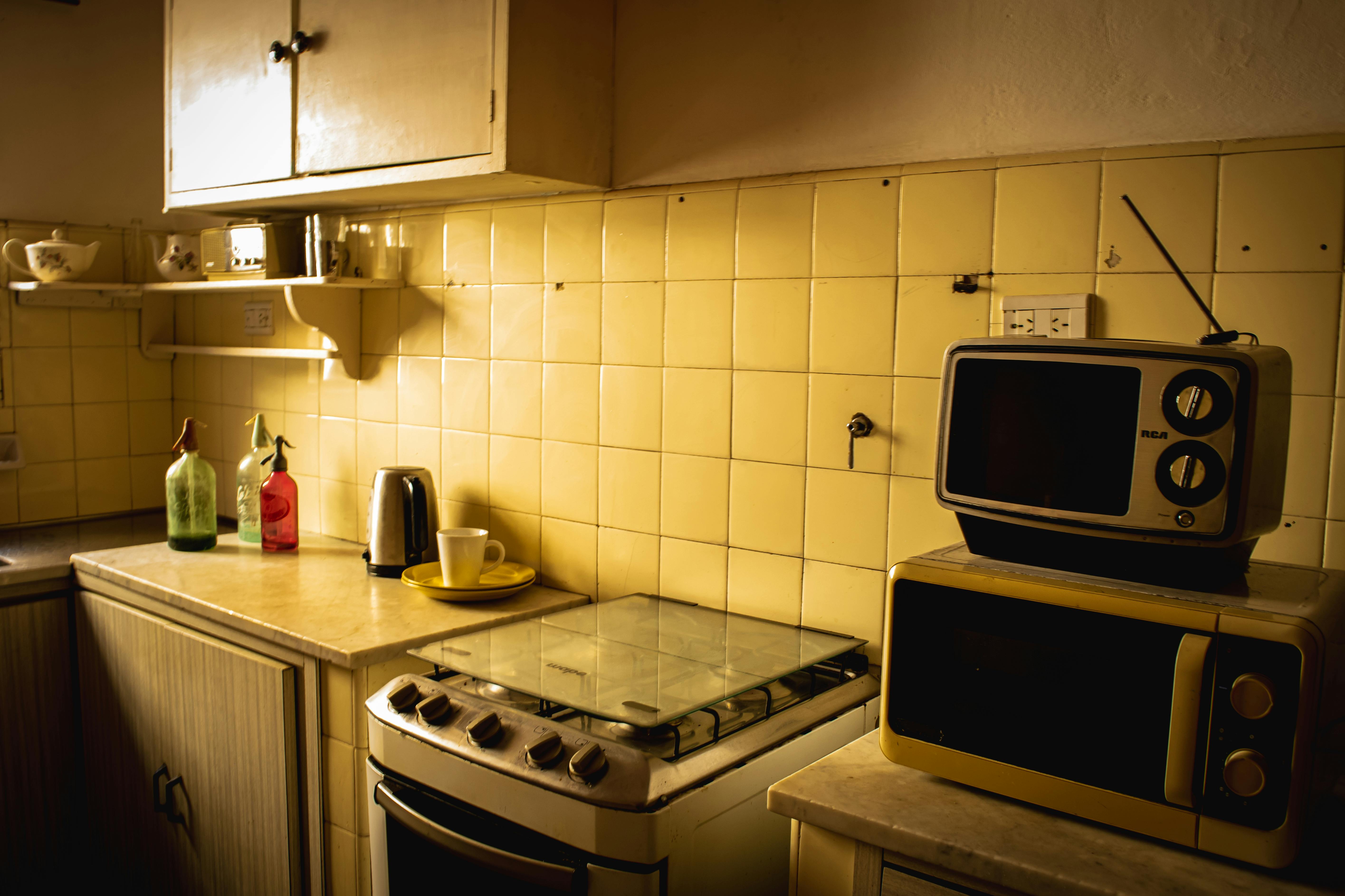 A nostalgic kitchen scene featuring vintage appliances and decor with warm lighting.
