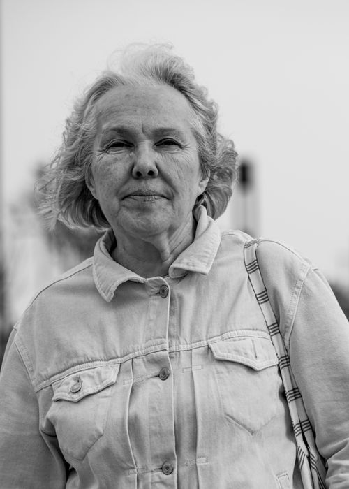 Free Monochrome portrait capturing a senior woman outdoors in a classic denim jacket. Stock Photo