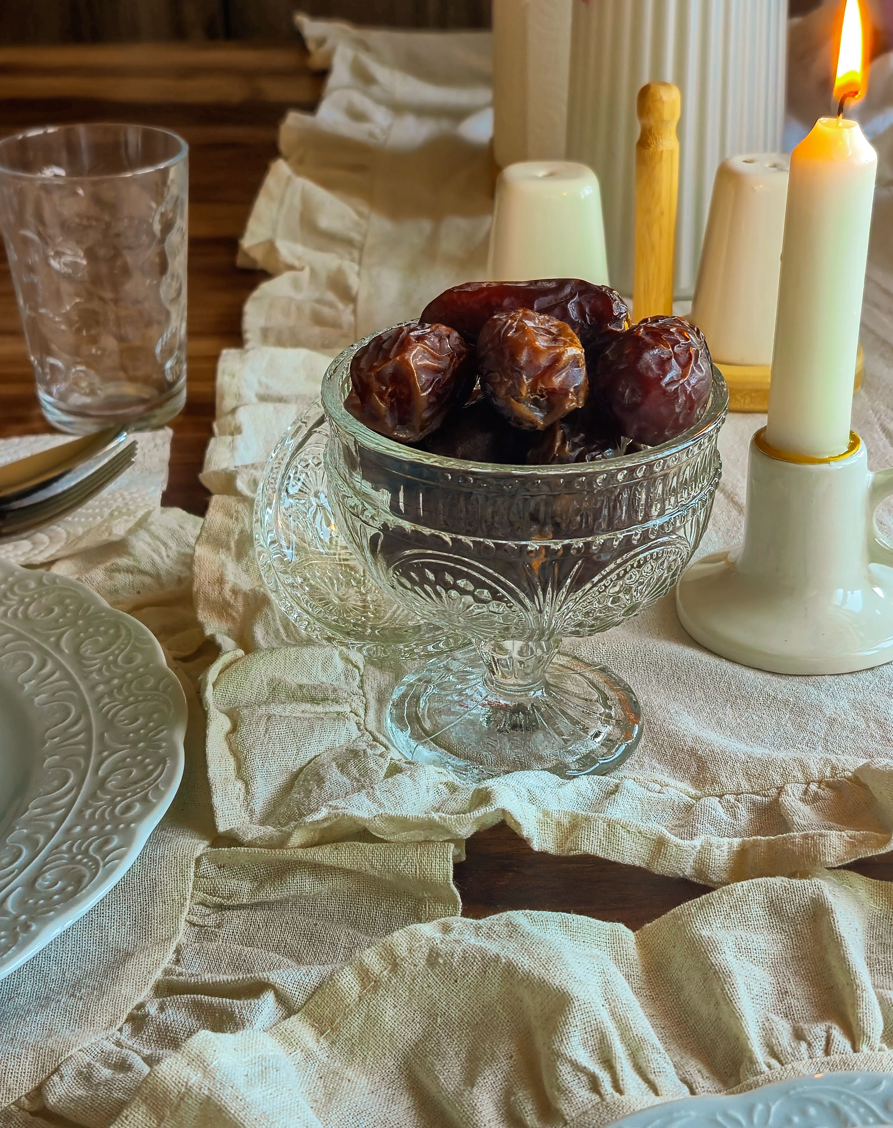 Elegant Table Setting with Dates and Candlelight · Free Stock Photo