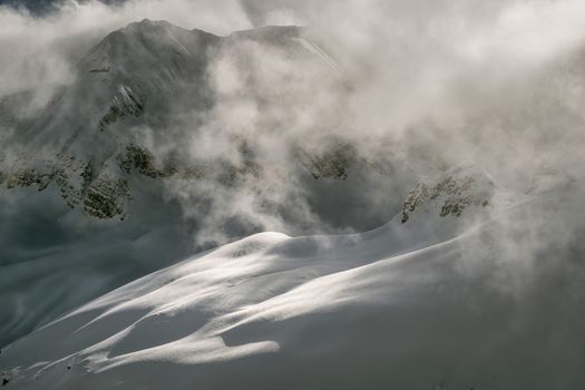 Snow-covered mountains in Panticosa, Aragón, enveloped in clouds.