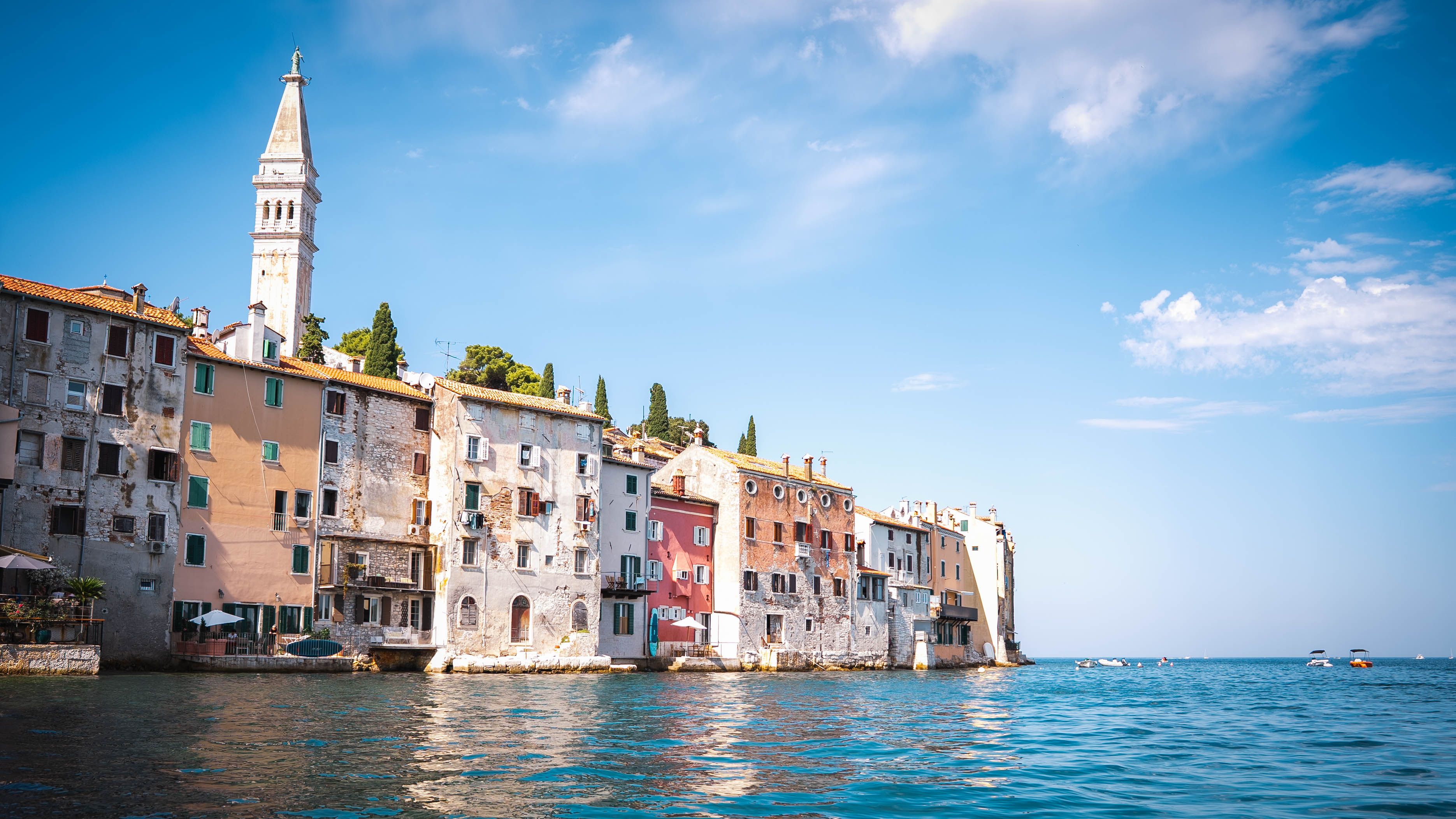 Gratis Vista panoramica dei colorati edifici sul mare e del campanile di Rovigno in una giornata di sole. Foto a disposizione