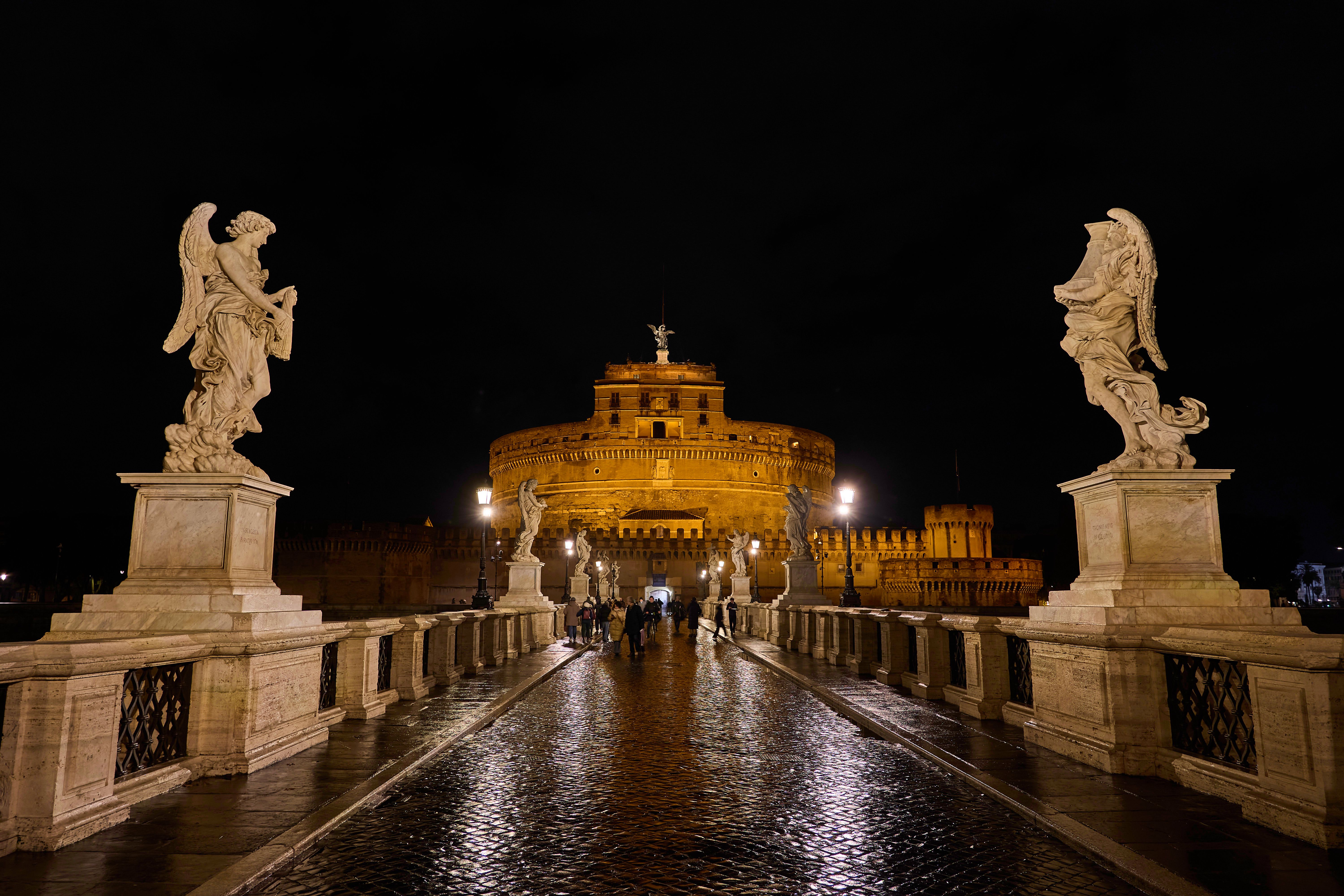 Enchanting night shot of Castel Sant'Angelo and Angel statues on Ponte Sant'Angelo in Rome, Italy.