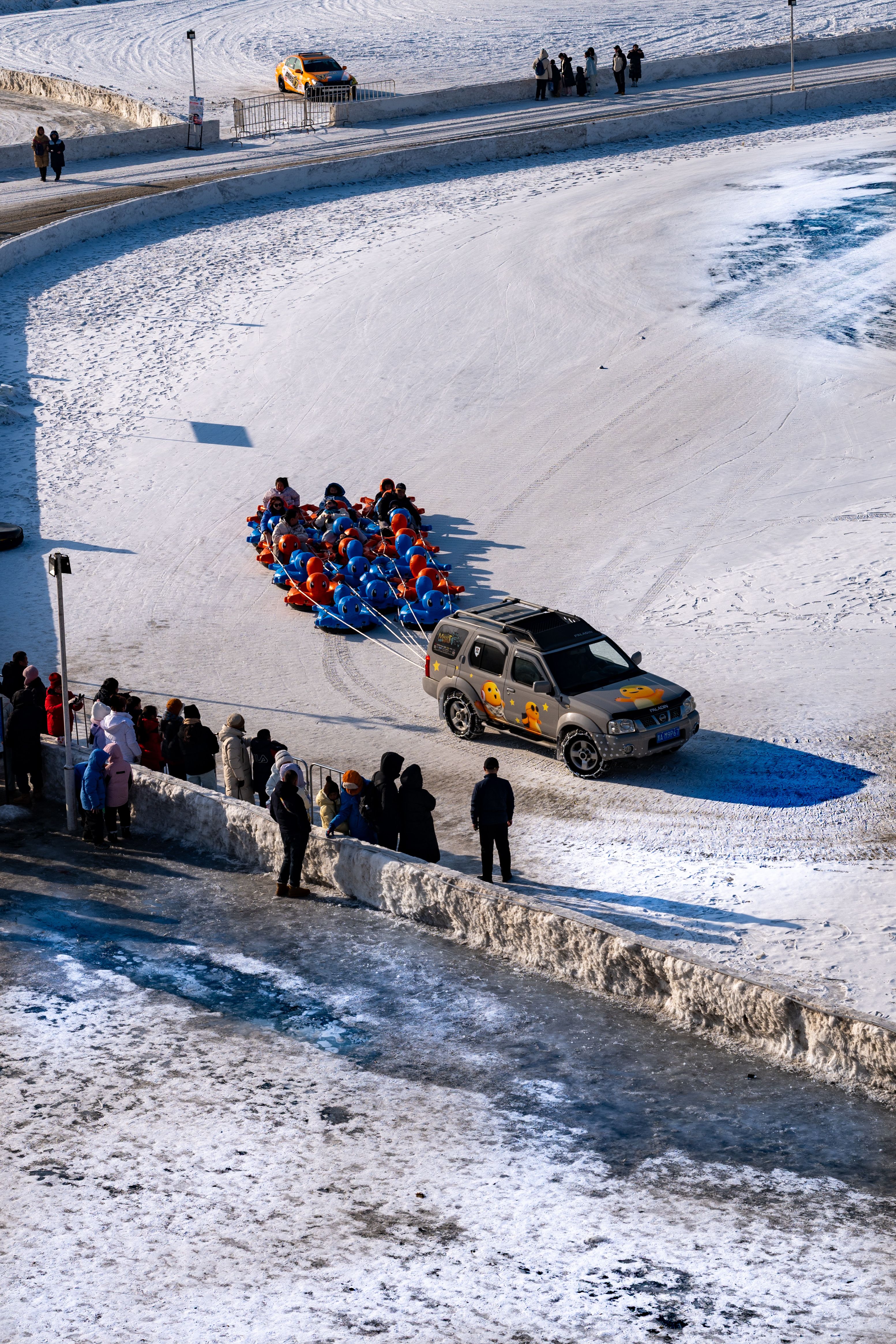 Exciting winter sledding experience with a group pulled by a vehicle in Harbin, China.
