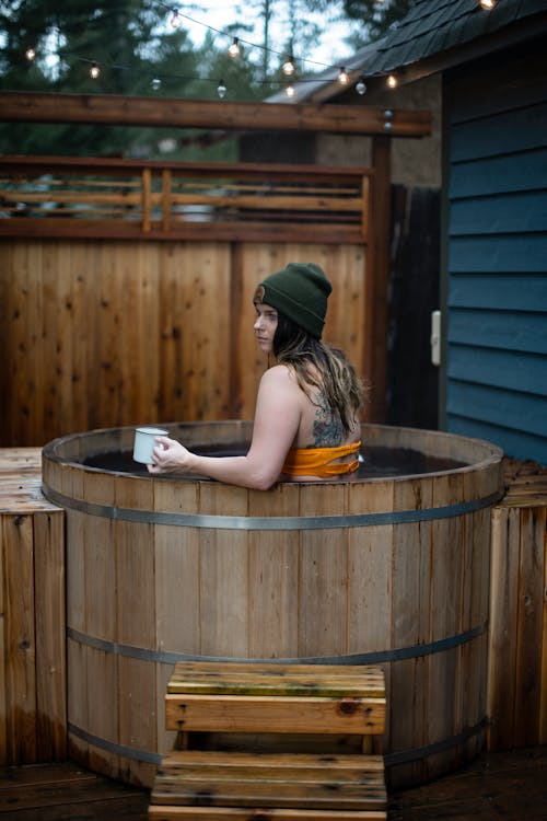 Free Woman Inside A Wooden Barrel Of Water Stock Photo