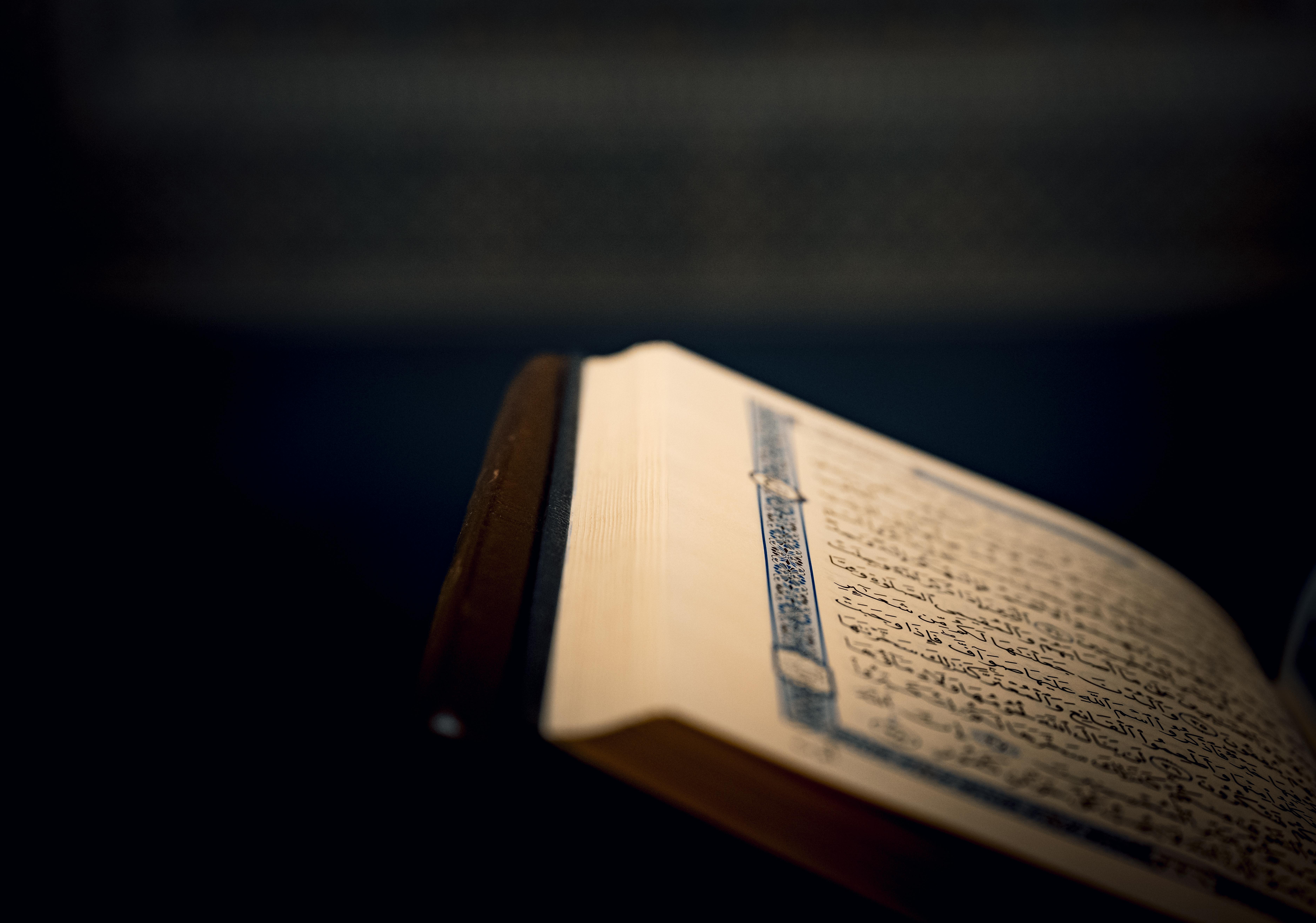 Free Close-up of a Quran page with intricate Arabic script. Stock Photo