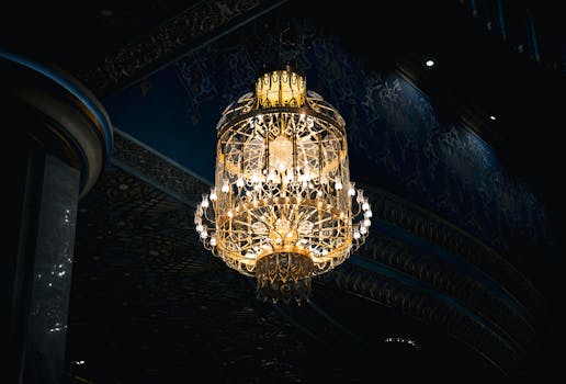 A stunning chandelier illuminates the intricate arabesque patterns in a luxurious interior setting, Kuwait City.