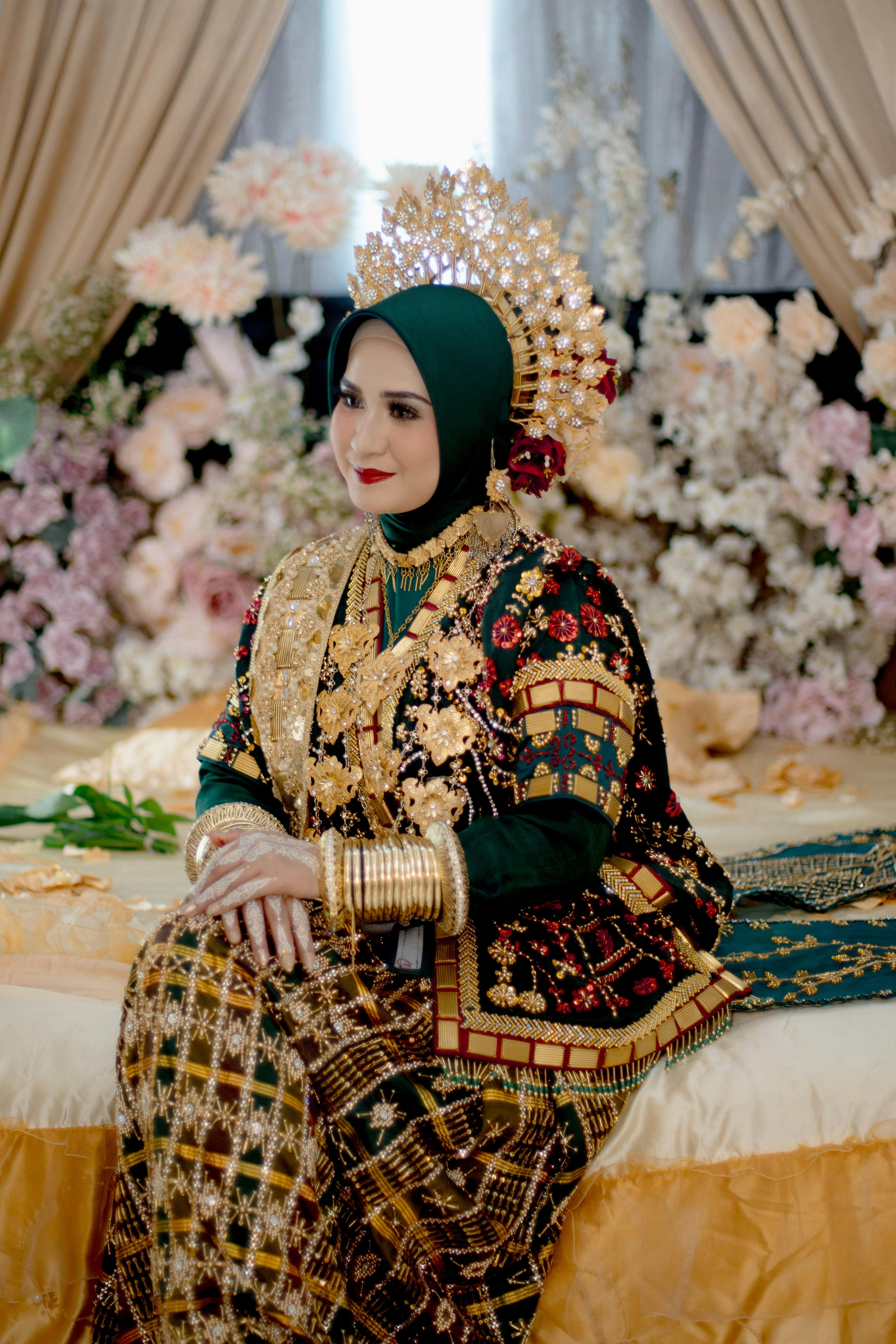 Elegant Bugis bride in traditional attire with intricate gold headpiece in Kendari.