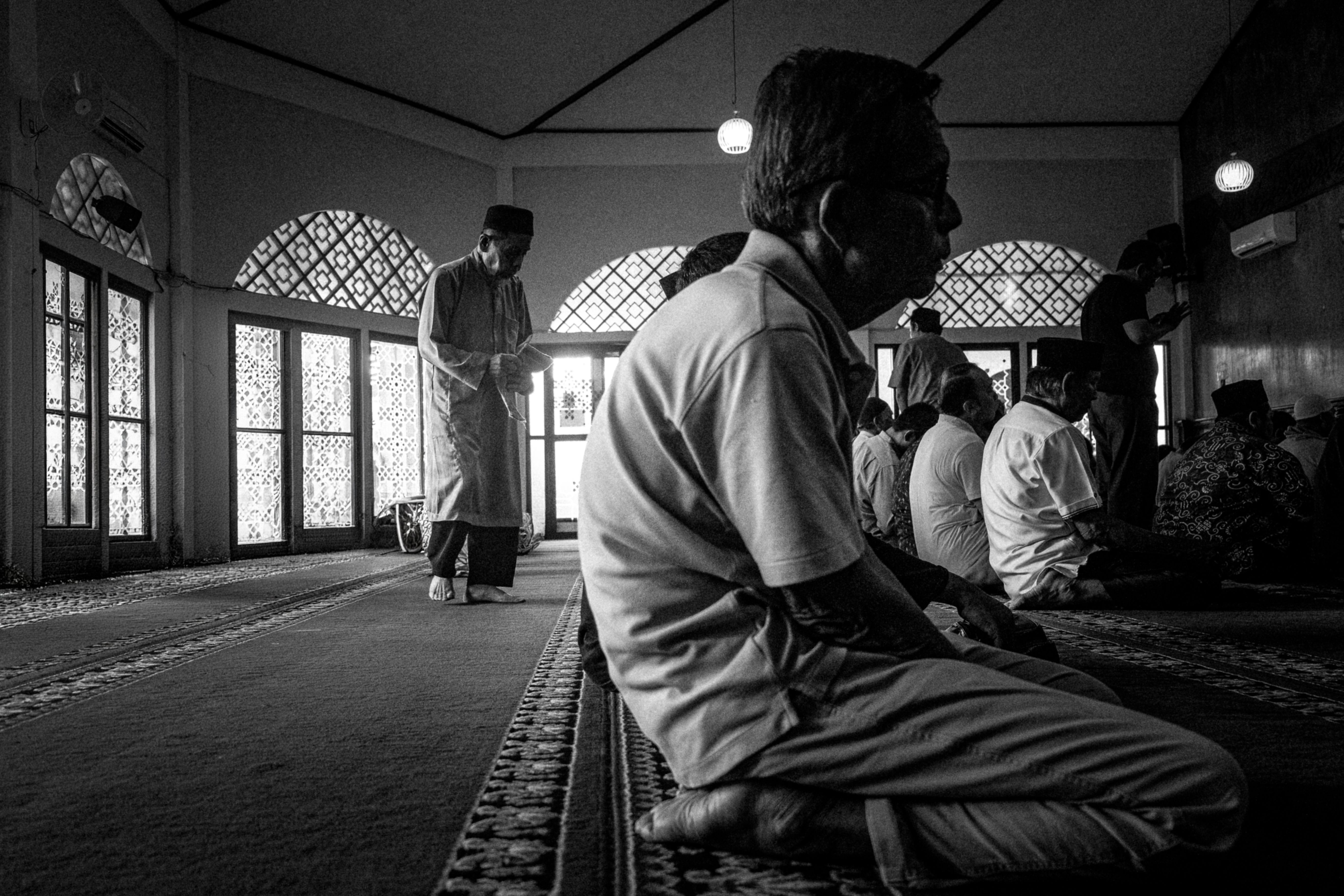 Candid Black-and-White Mosque Prayer Scene · Free Stock Photo
