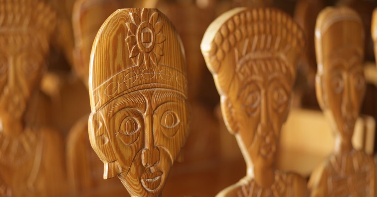 close-up of a Vodun shrine with offerings and carved wooden figures
