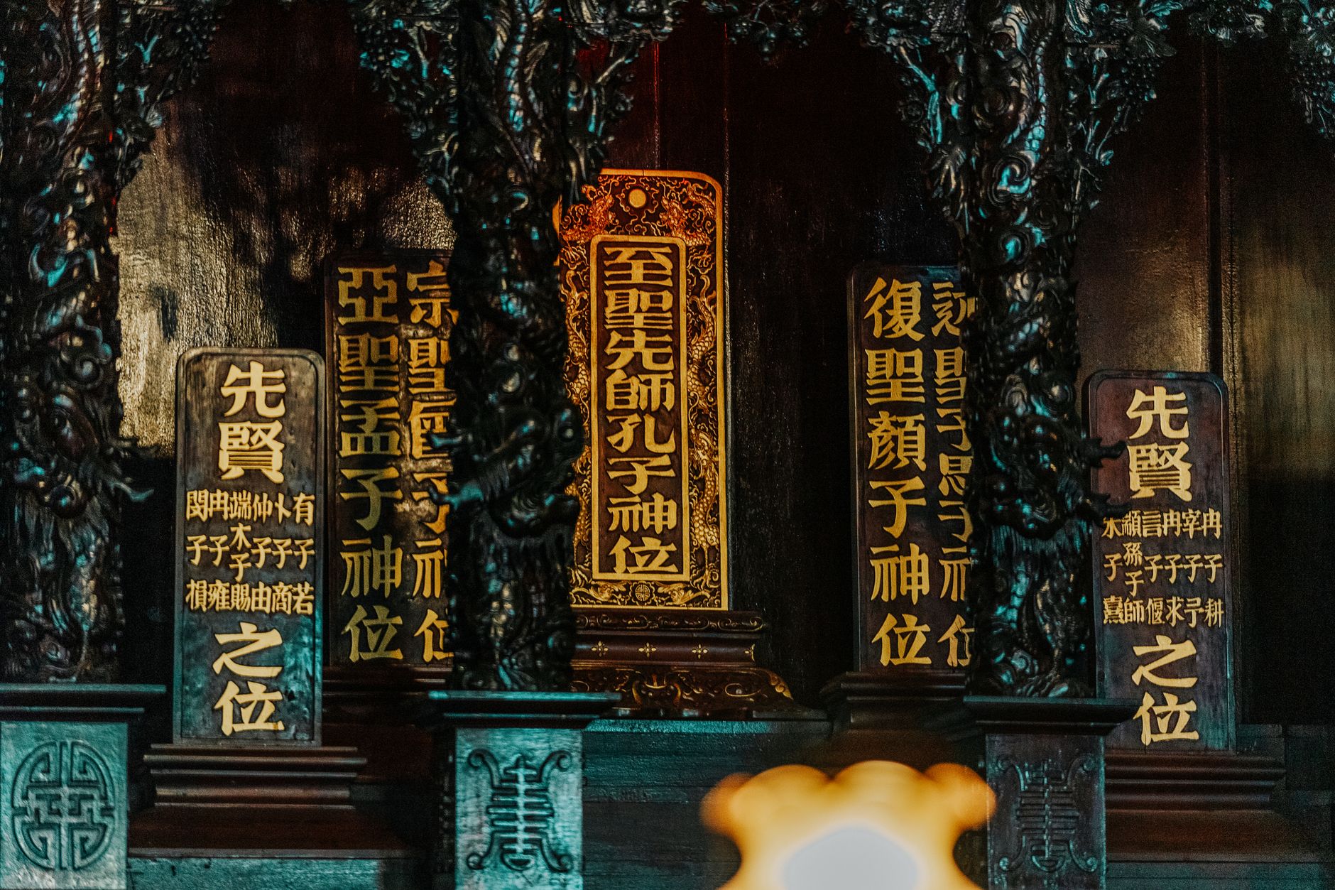 Traditional Chinese ancestral shrine with ornate wooden panels and calligraphy.