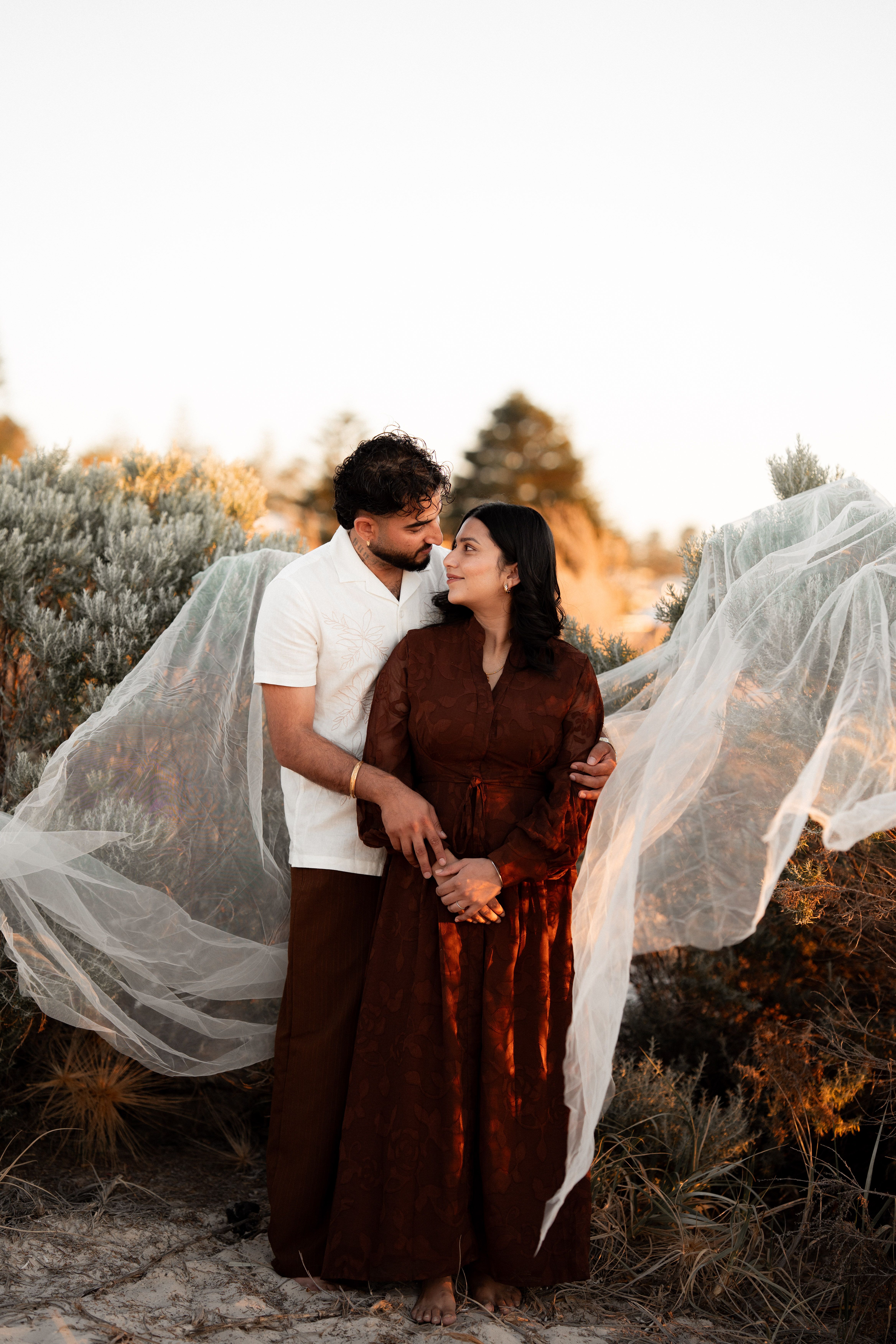 Romantic Couple Embracing Outdoors at Sunset · Free Stock Photo