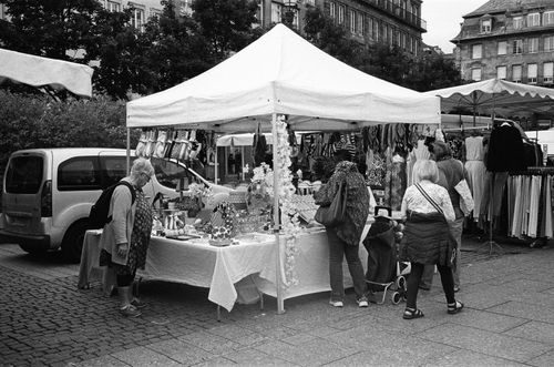 Free A vibrant outdoor market in Strasbourg with people browsing stalls under tents. Stock Photo