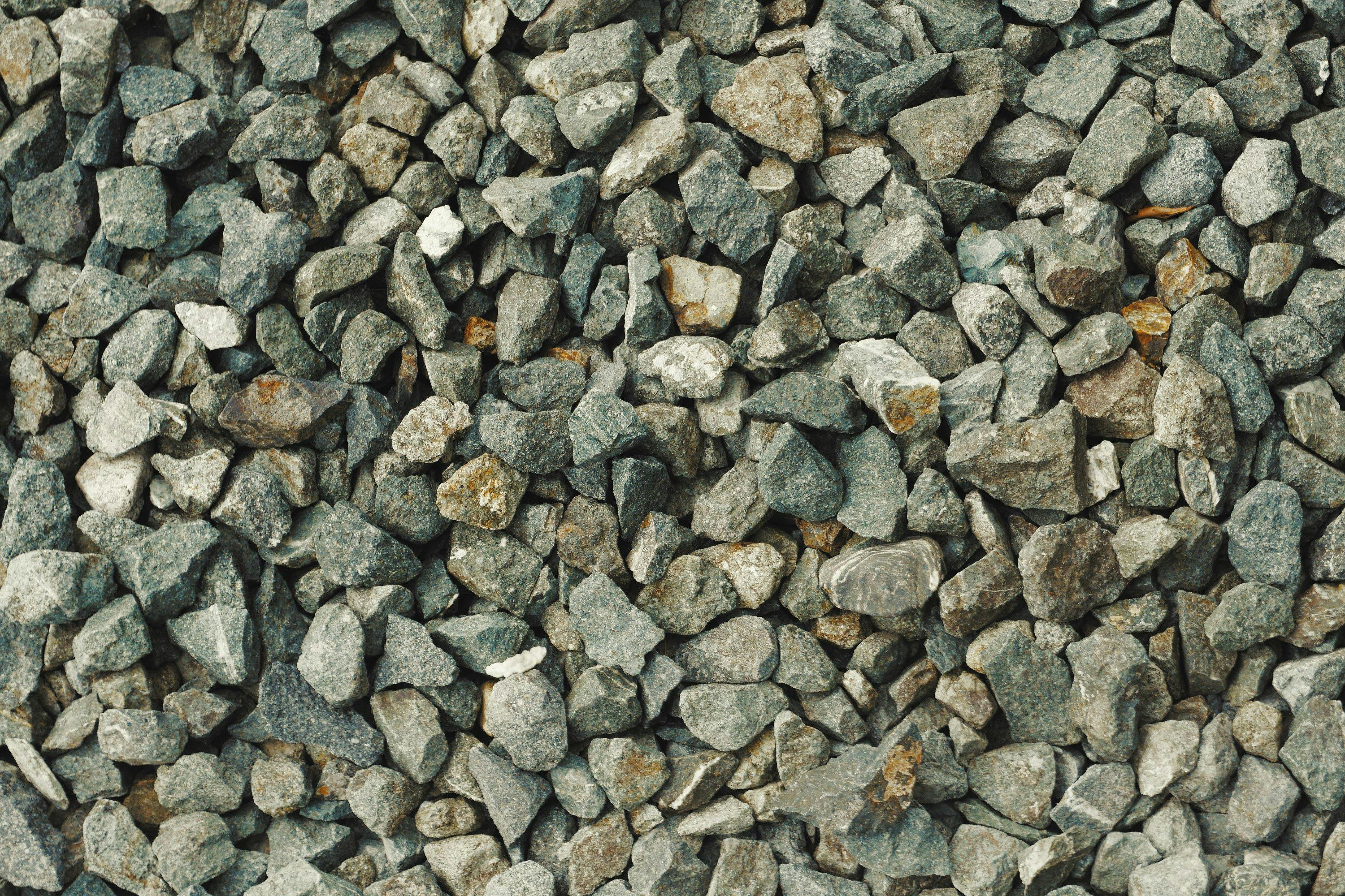 Gratis Et billede i høj opløsning af ru grå grussten, der giver en tekstureret baggrund. Lagerfoto