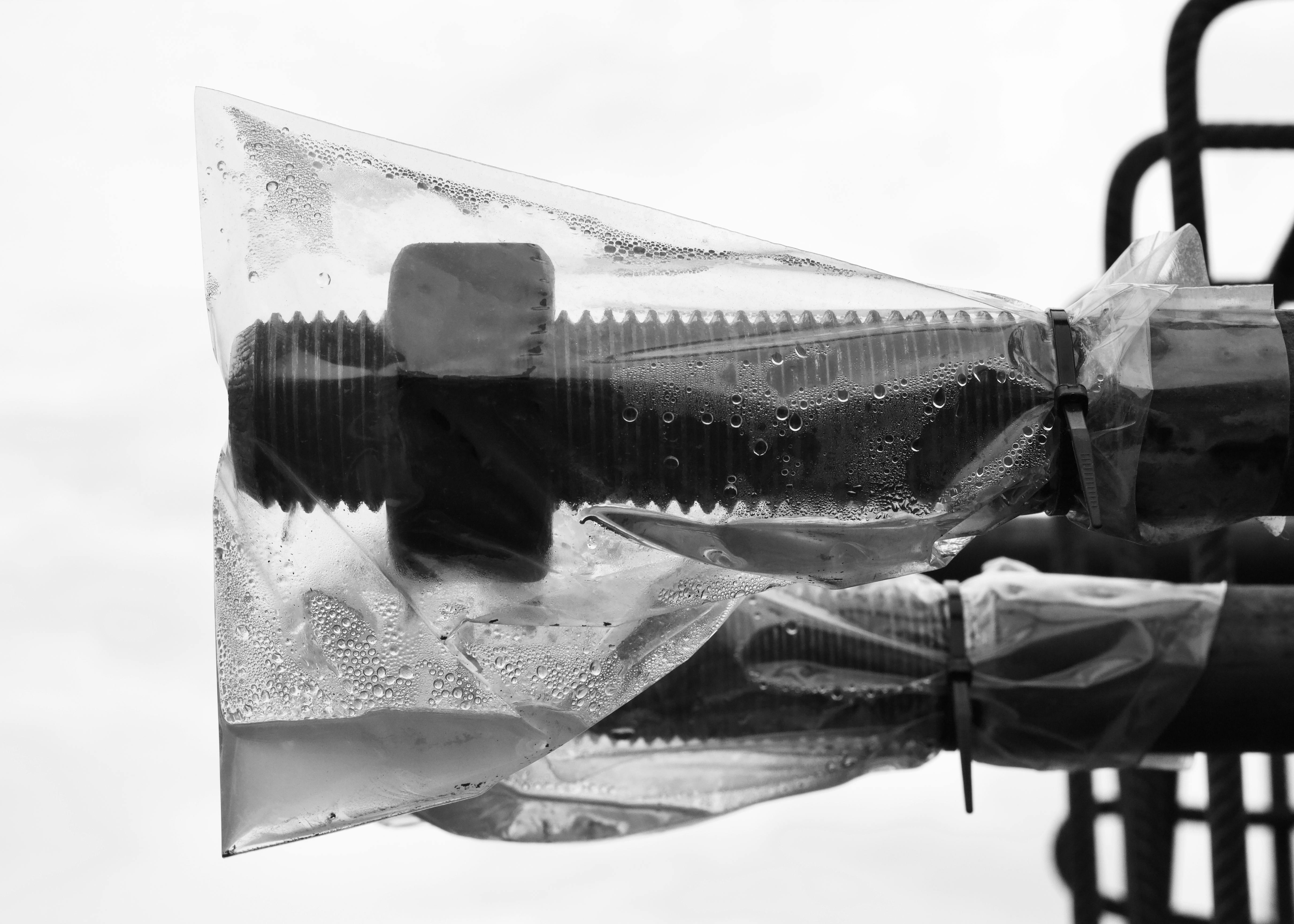 Free Close-up of a metal fastener wrapped in plastic, highlighting texture and form. Stock Photo