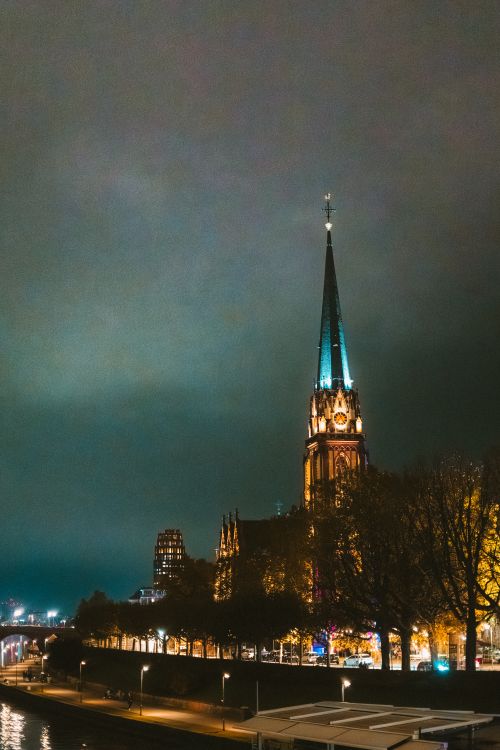 Free A night view of the illuminated Frankfurt Cathedral in Frankfurt am Main, Germany with a dramatic sky. Stock Photo