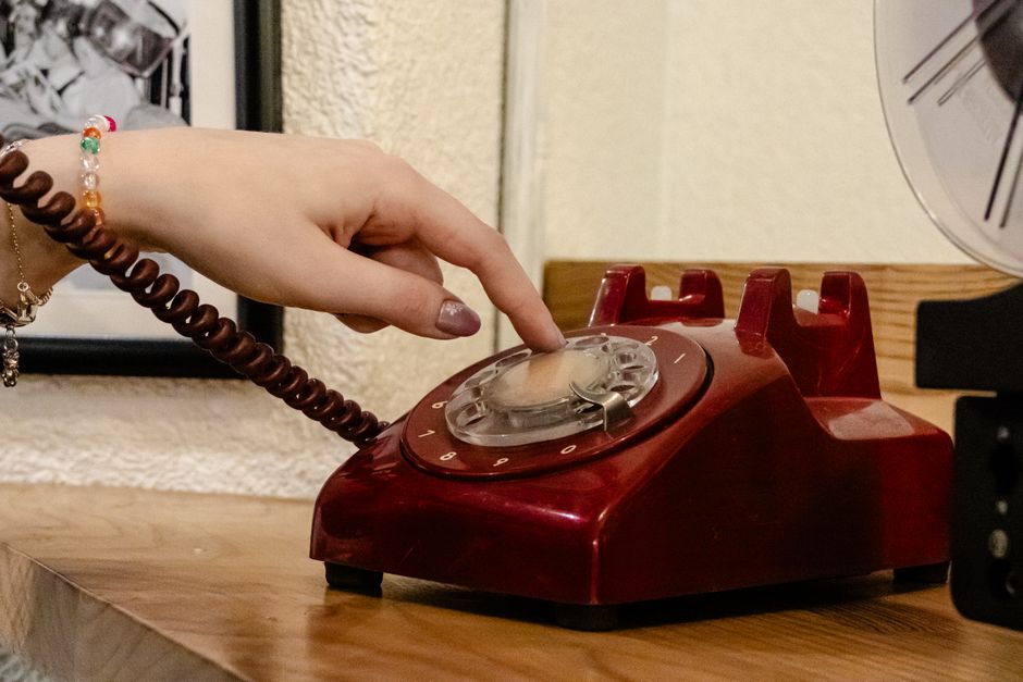 hands dialing phone counter