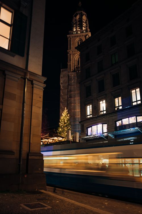 Free A night view of a tram in Zürich with Fraumünster Church and Christmas lights. Stock Photo