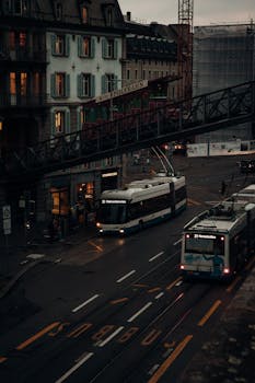 Tram number 31 navigating through Zürich city streets at dusk, featuring urban architecture and the Polybahn.