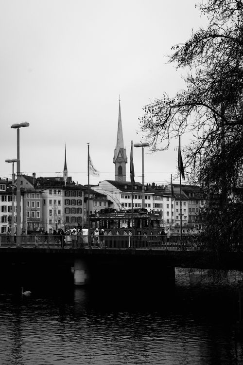 Free Monochrome view of a bridge and spire in Zürich, Switzerland, capturing city life. Stock Photo