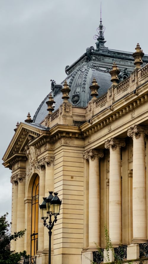 Free Ornate exterior of a historic European building featuring pillars and detailed stonework. Stock Photo