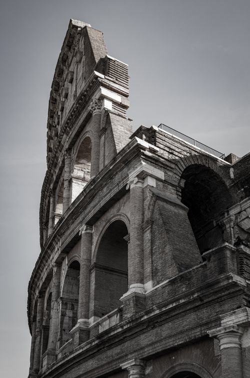 Free Dramatic angle of the iconic Roman Colosseum under a clear sky in Rome, Italy. Stock Photo
