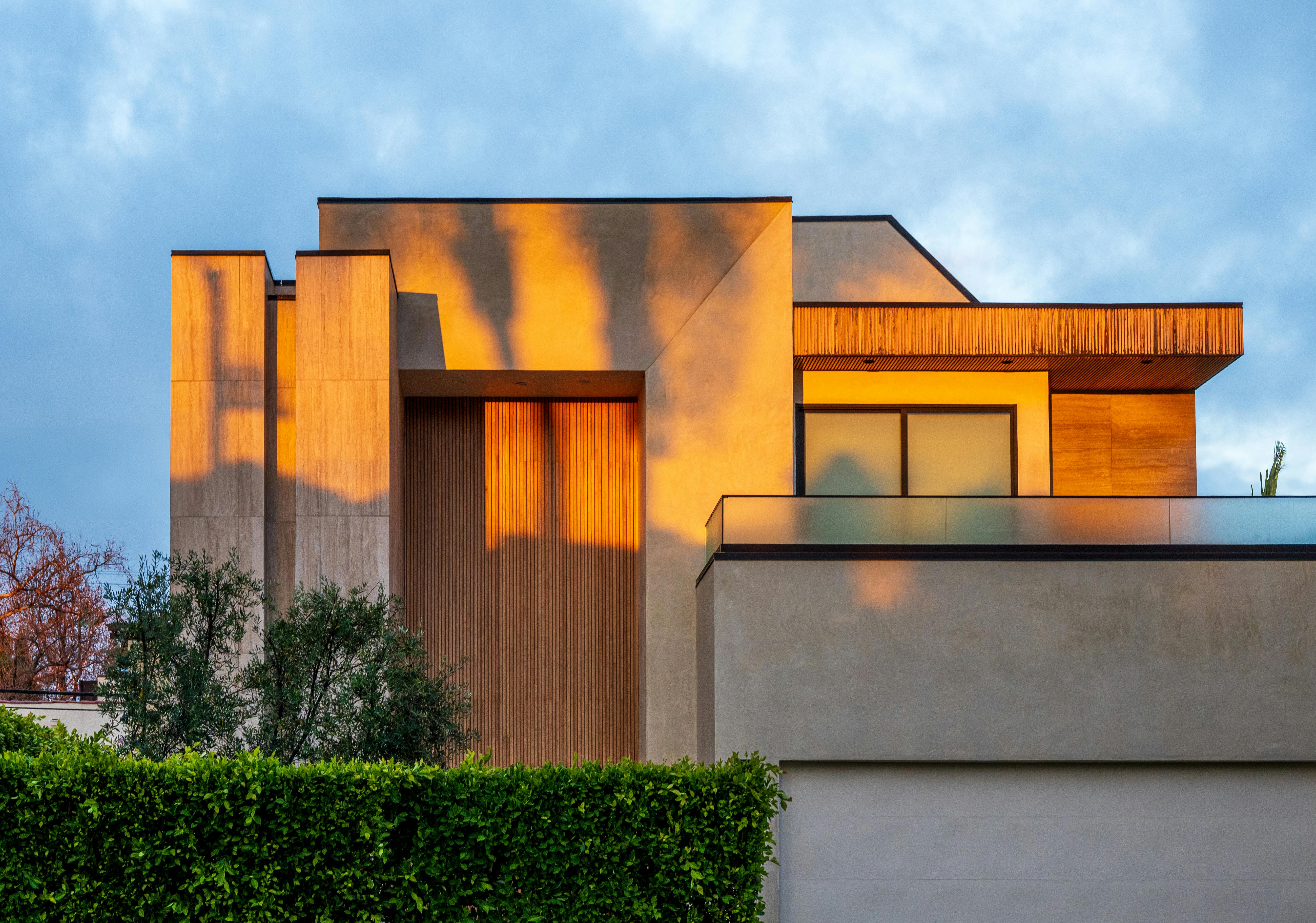 Contemporary luxury home exterior with clean architectural lines at sunset