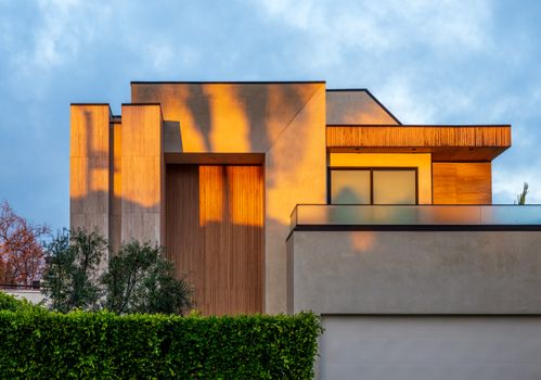 Modern home exterior with warm sunset reflections in West Hollywood, California.