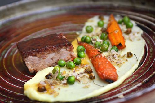Free Delicious gourmet dish featuring braised pork, carrots, peas, and mashed potatoes, elegantly plated. Stock Photo