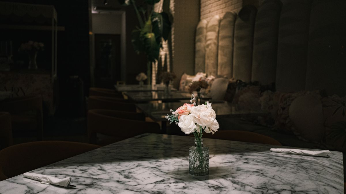 Elegant restaurant interior with marble table and floral arrangement