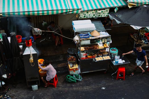 A bustling street food stall in an urban market showcasing local cuisine and street life.