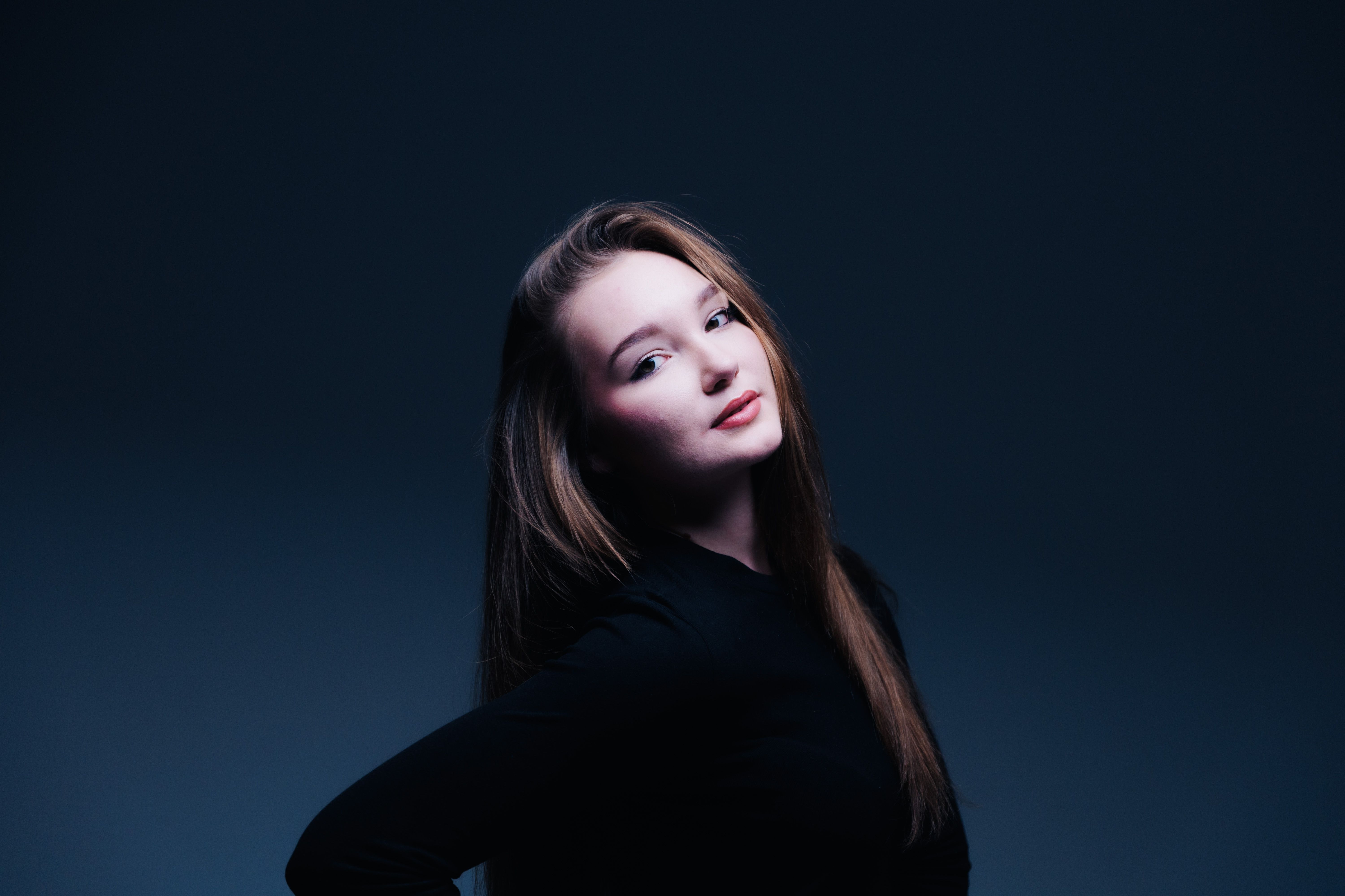 Stylish Portrait of a Young Woman in Studio Lighting · Free Stock Photo