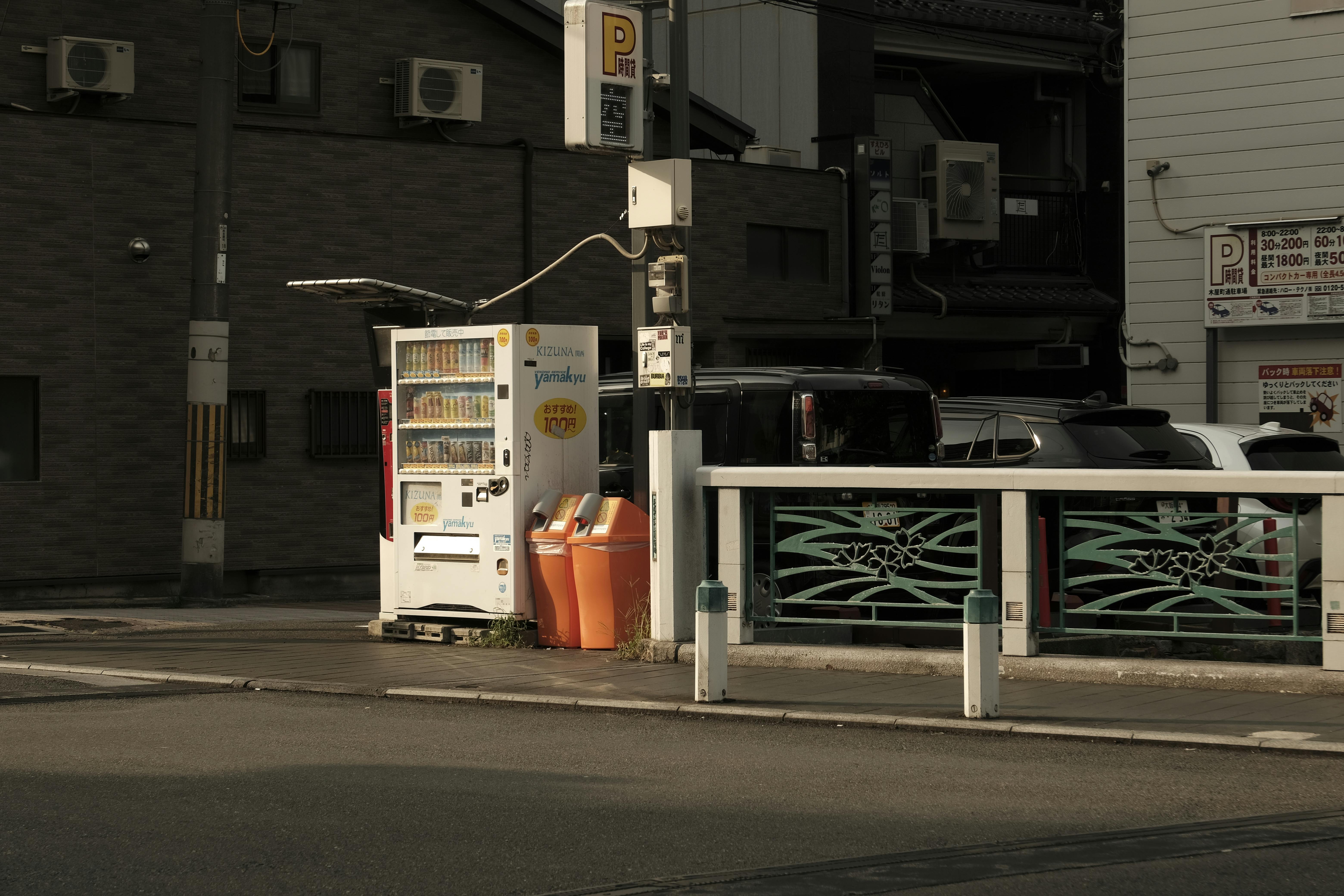Free Urban street in Japan featuring a vending machine and parked cars in a quiet neighborhood. Stock Photo
