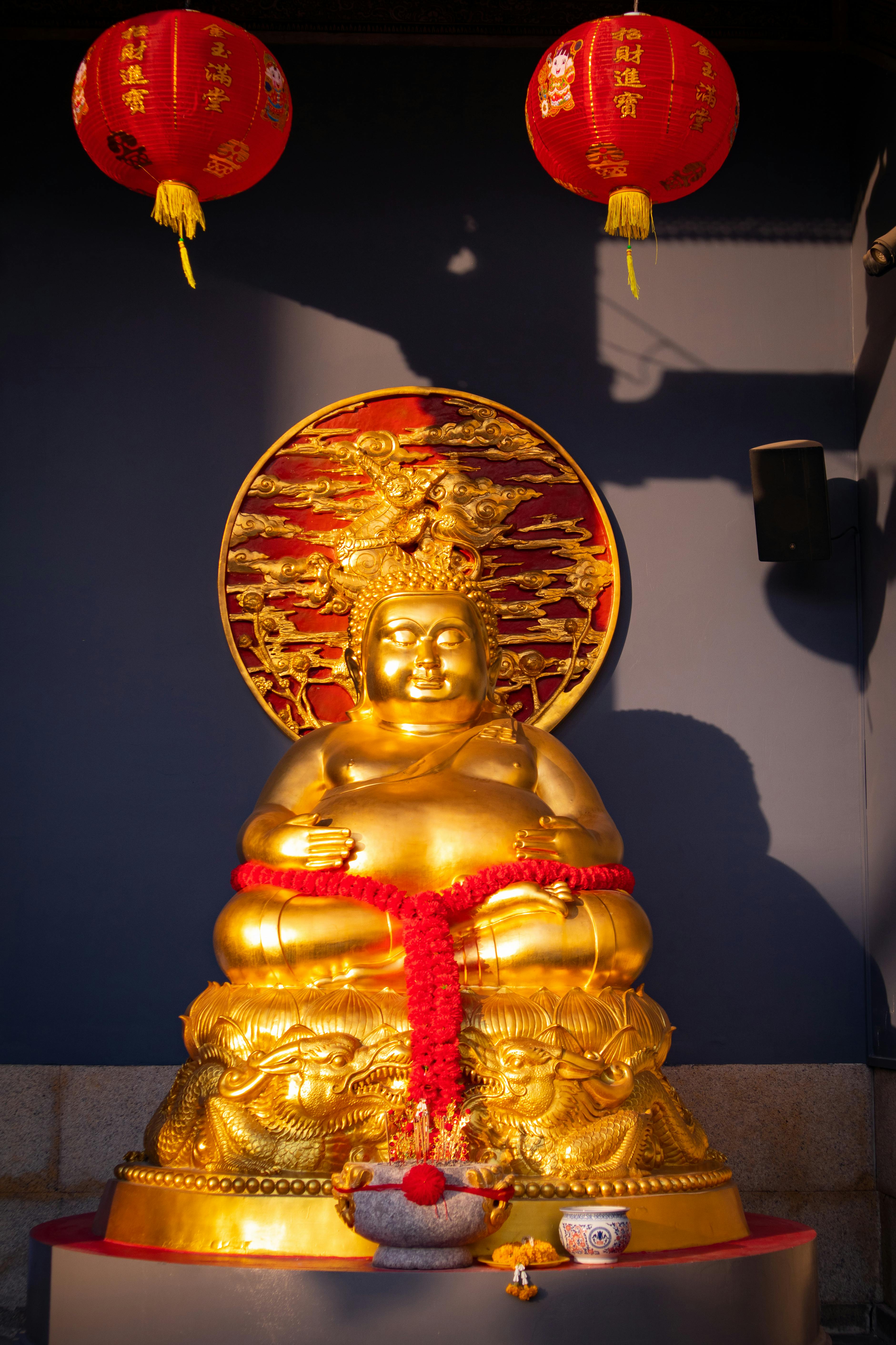 gold and red buddha figurine