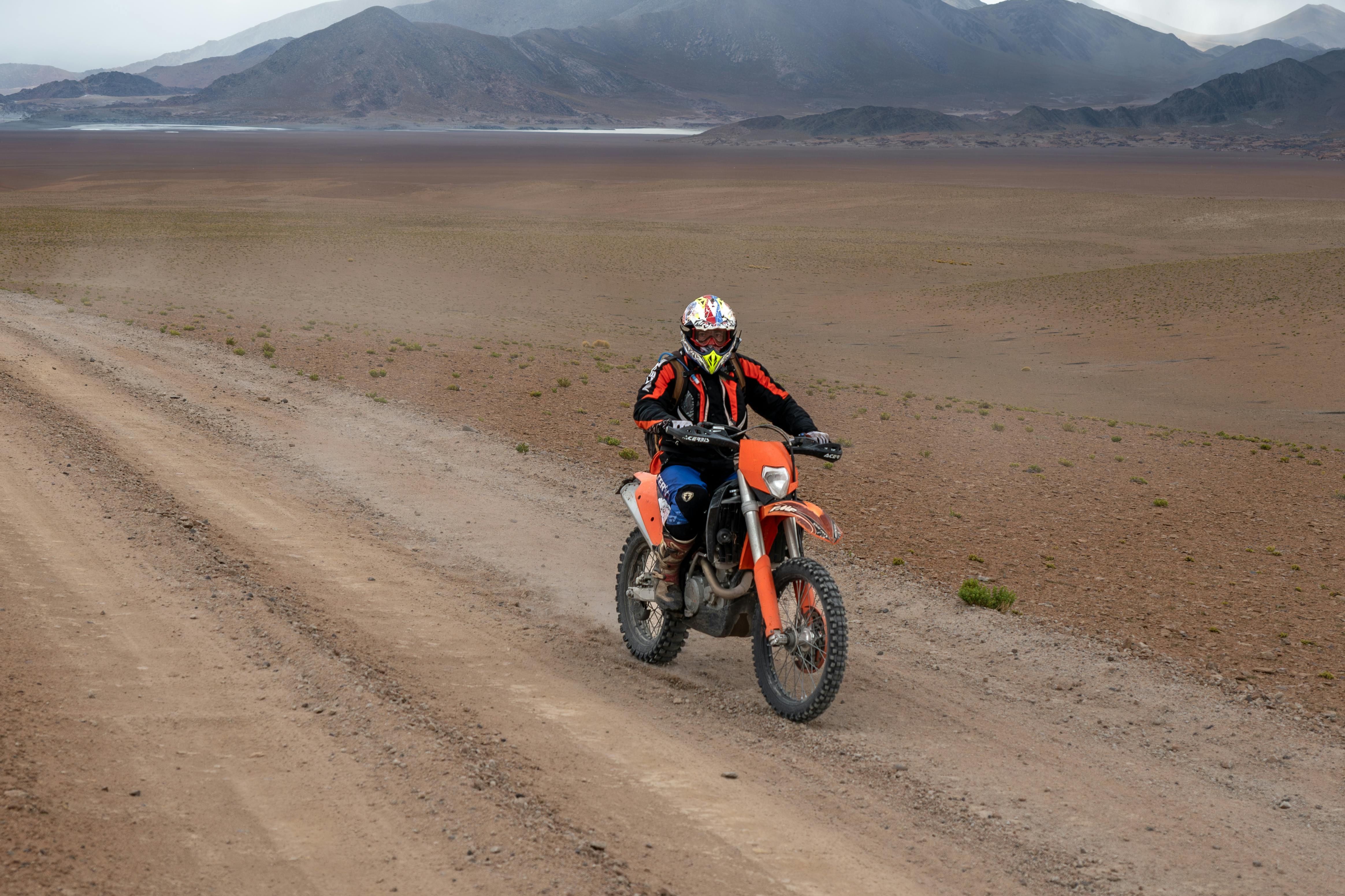 A motorcyclist rides through the stunning desert landscape of Catamarca, Argentina.
