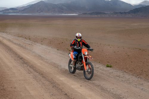Free A motorcyclist rides through the stunning desert landscape of Catamarca, Argentina. Stock Photo