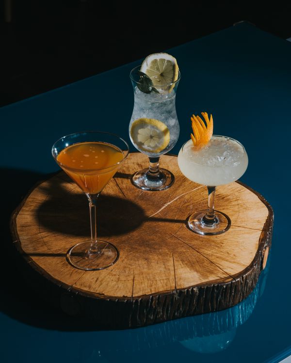 Elegant Cocktails on Rustic Wooden Surface · Free Stock Photo