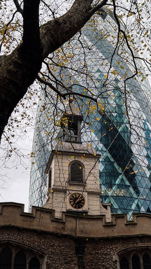 Free Juxtaposition of a historic church with the modern Gherkin skyscraper in London. Stock Photo