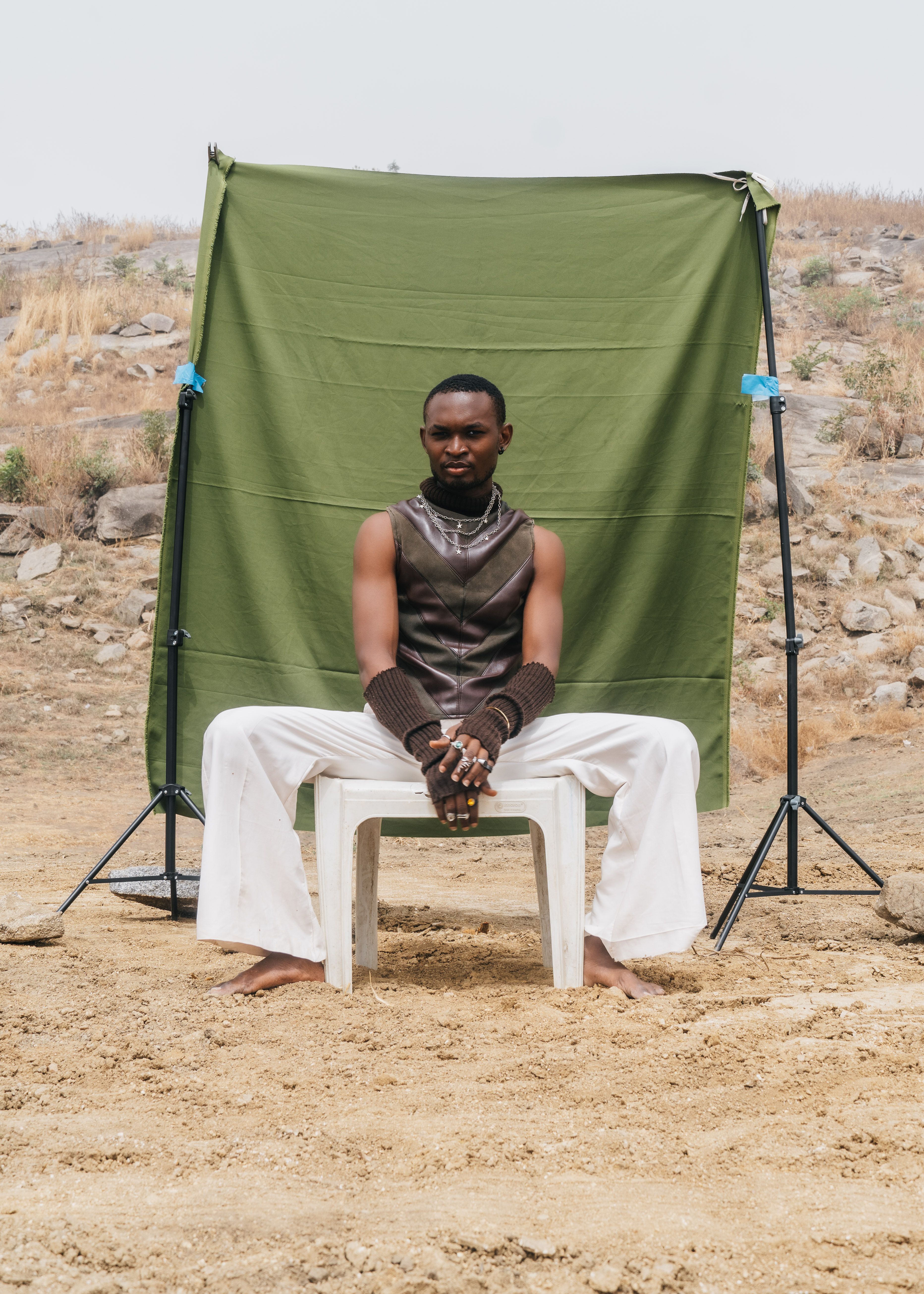 Portrait of a man sitting outdoors in Abuja, Nigeria.