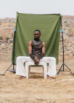 Portrait of a man sitting outdoors in Abuja, Nigeria.
