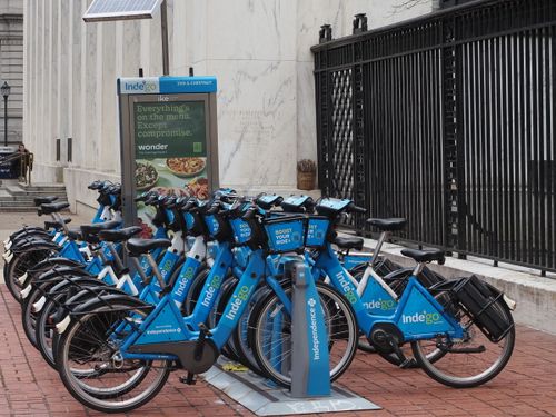 Free Row of Indego share bicycles at a Philadelphia station, promoting eco-friendly city travel. Stock Photo