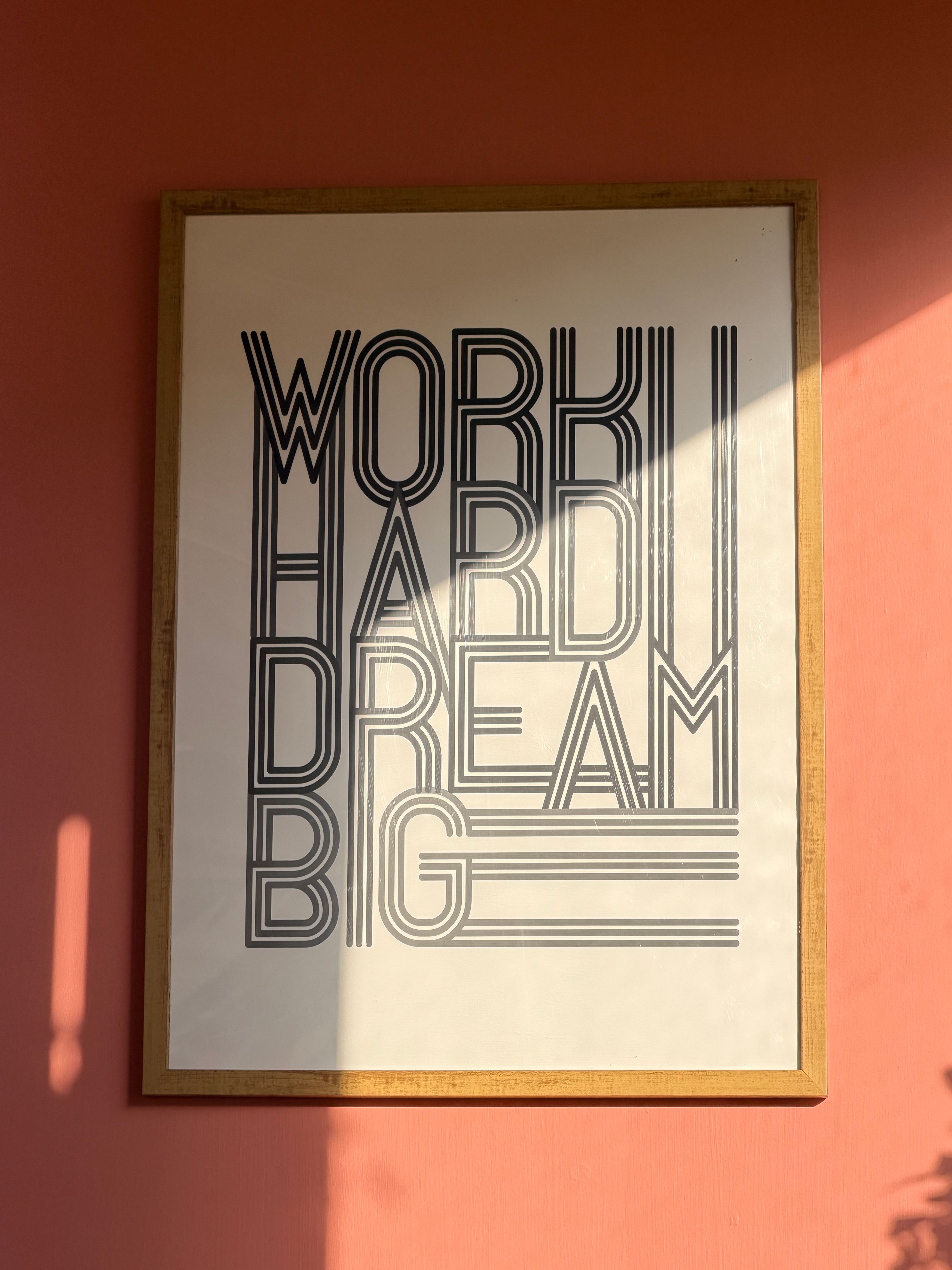 typography poster with large letterforms on a wall