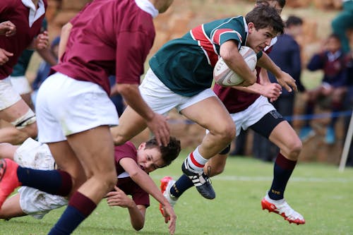 Free Group of Men Playing Rugby Stock Photo