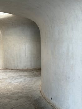 Curved concrete walls capture minimalist architecture. Ideal for modern design concepts.