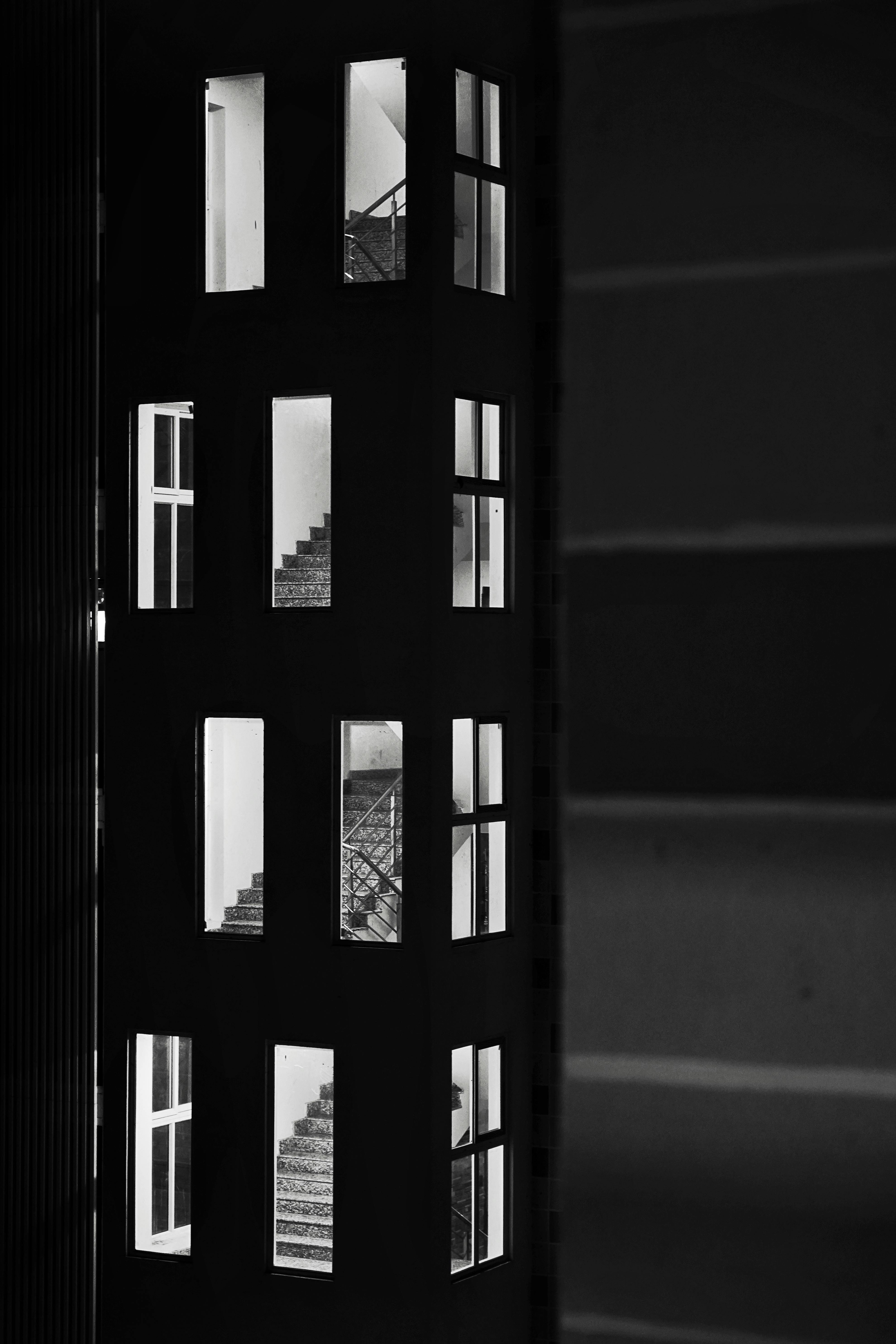 Free Monochrome view of building facade showcasing visible staircases. Stock Photo
