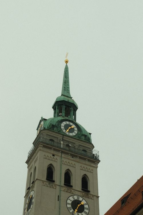 Free View of St. Peter's Church tower with green copper roof in Munich, Germany. Stock Photo