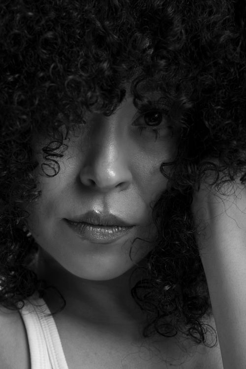 Black and White Portrait of a Woman with Curly Hair · Free Stock Photo