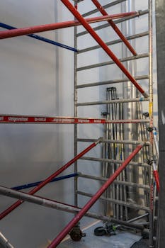 Metal scaffolding setup inside a construction site in Amsterdam.